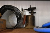 Items on shelf to include hose for air and antique burner torch and more