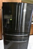 Samsung refrigerator and freezer with water and ice in the door and a separate area for keeping