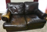 Leather Love seat with a little wear on the seat and arm rest, Solid love seat and very comfortable