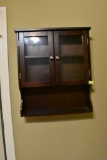 Small wooden 2 door cabinet with bottom shelf.