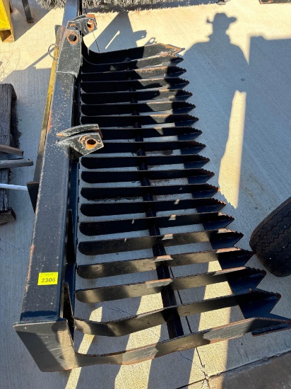 Skid steer rock bucket. Bottom is bent needs some work Must bring help to load, skid steer on site
