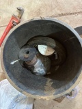 Bucket of various items including a wrench