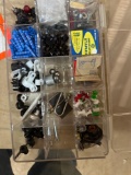 Small plastic storage container with various items inside