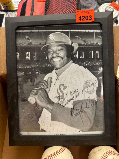 Baseballs in a frame picture of a baseball player