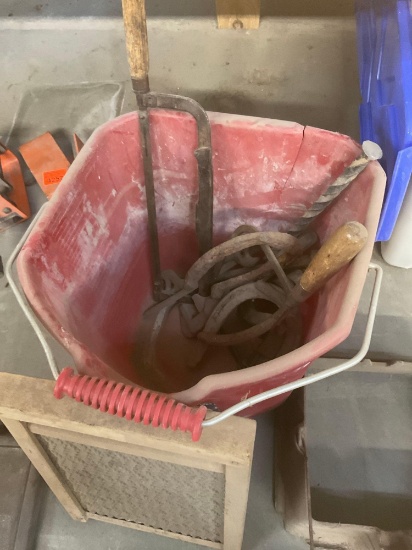 Bucket of horseshoes, nails , coping saw , hacksaw , antique washboard, antique waffle maker