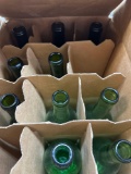 Dozen wine bottles, four brown eight green