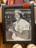 Baseballs in a frame picture of a baseball player