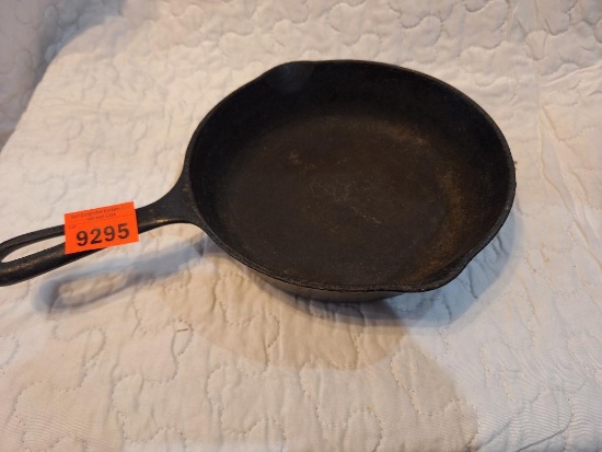 small cast iron skillet- lays flat-approx 6 inches wide brand unknown.