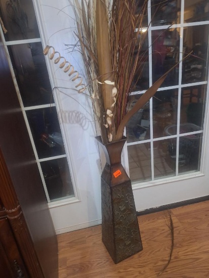 Metal vase with dried grasses