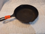 small cast iron skillet- lays flat-approx 6 inches wide brand unknown.