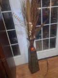Metal vase with dried grasses