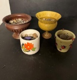Metal bowls and pots full of rocks