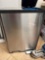 Metal container with foot pedal to open door