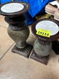 Two candle holders, five candles, top of smaller candle holder is broken