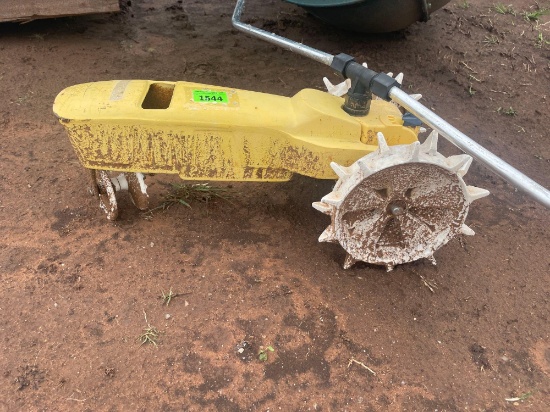 J- yellow and white tractor water sprinkler