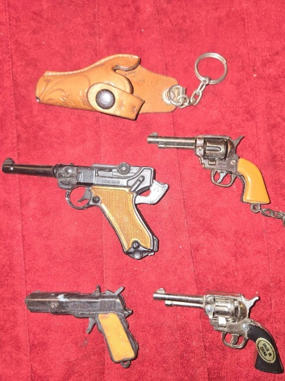 4 Assorted, Vintage , Small Cap Guns and Key Chains. Plus 1 Keychain Holster. All one Money.
