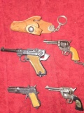 4 Assorted, Vintage , Small Cap Guns and Key Chains. Plus 1 Keychain Holster. All one Money.