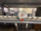 Contents on shelf, which include PVC HVAC 22s, white spray paint, PVC cement, pipe, thread sealant,