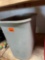 Trashcan with miscellaneous items inside