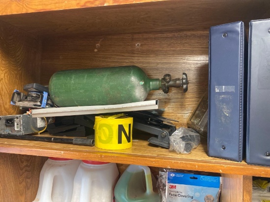 This lot contains items on shelf which include caution tape, oxygen bottle, Three ring binders and