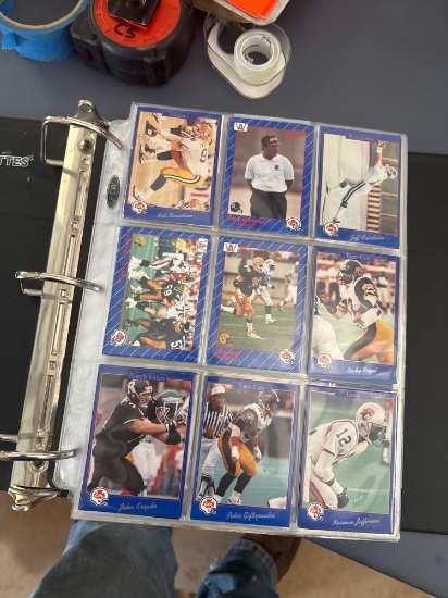 Baseball football, basketball cards and a three ring binder