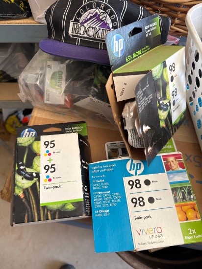 HP printer cartridges and a Colorado Rockies hat