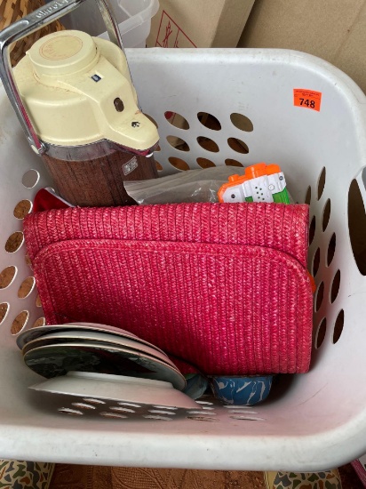 Plastic laundry tote with cardinal plates, golf balls, typing books, old thermas, water gun, and