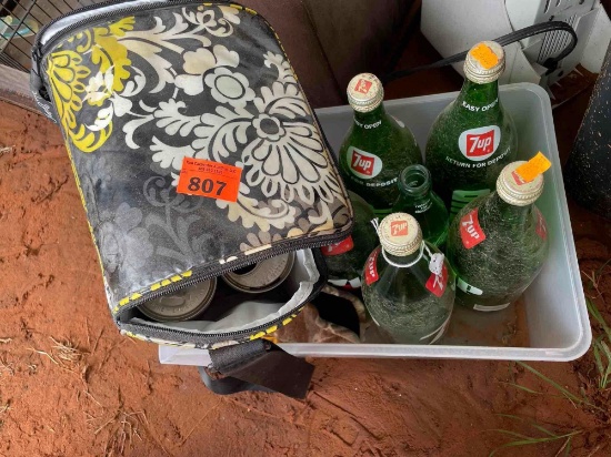 Vera Bradley lunch pale with empty Pepsi cola cans inside, glass 7 up bottles, and metal toy trucks