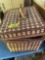 Wicker picnic basket full of plastic dishes