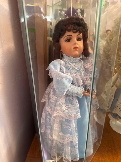 porcelain doll in glass case