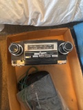 Vintage car stereo with speaker covers and speaker wires