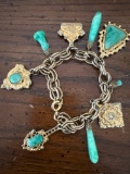 green stone charm bracelet, pin-pendant with green stone