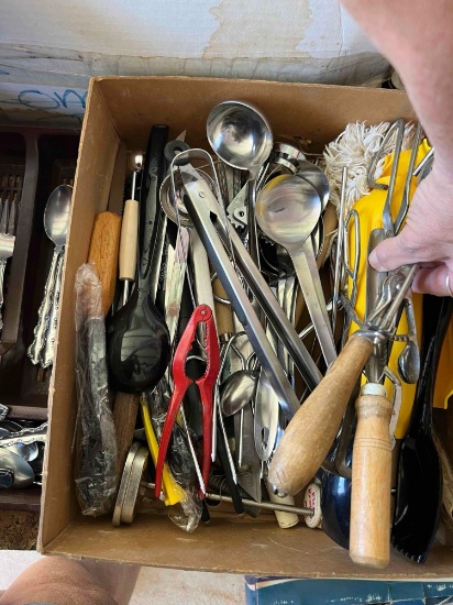 Box with tongs, ladles, melon baller, potato masher and other kitchen utensils