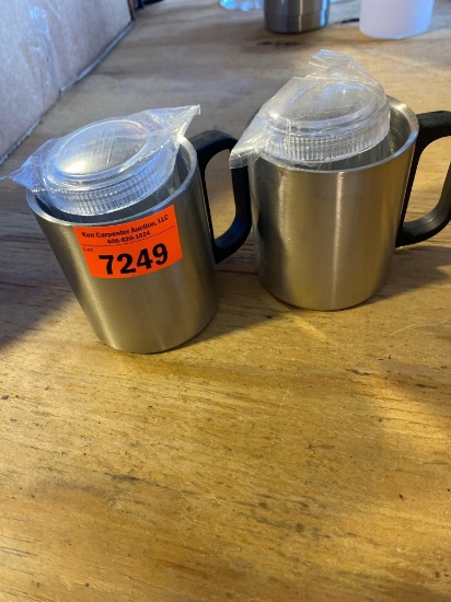 Two metal coffee, mugs, and two clear containers with lids