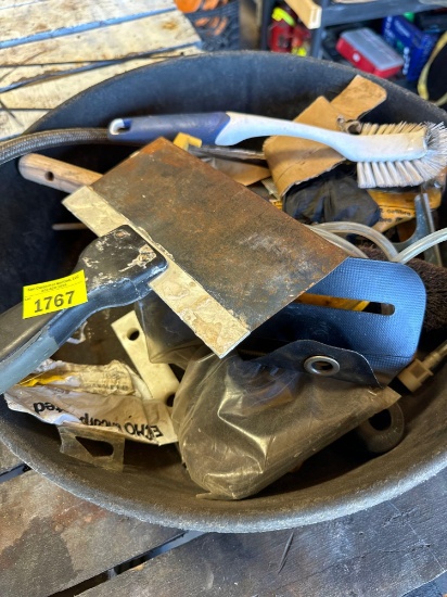 Scraper, scrub brush, fittings in a plastic spill container