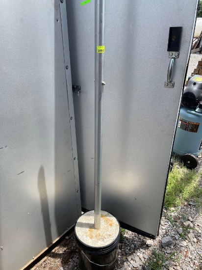 2 Poles in concrete and an orange cone Buyer to bring help to load