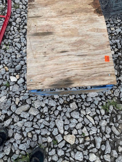 Metal cradle with piece of wood