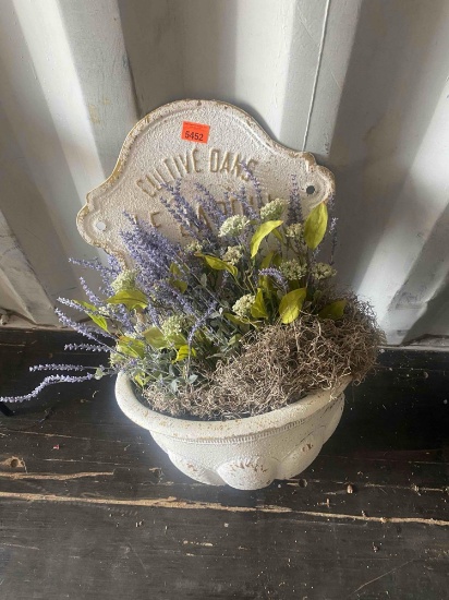 Artifical plant in a wall plant holder