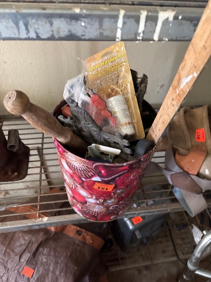 Miscellaneous items in tin bucket