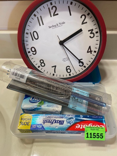 Clock, conair comb, scalp massager, pencil box, toothpaste and soap