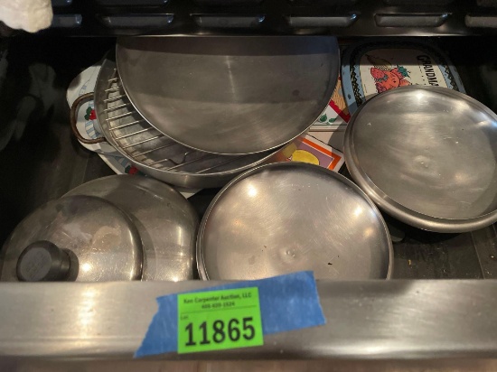 Drawer under oven, contents only. Hot pads, pot lids, and more