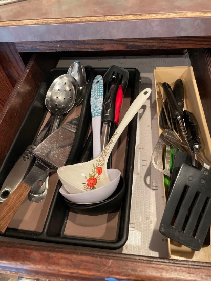 Drawer of kitchen utensils in organizing trays