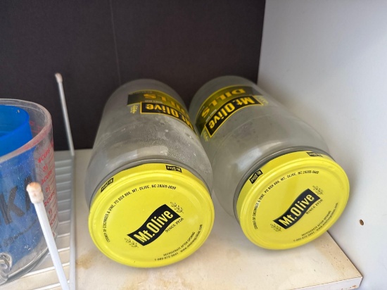 measuring cup plastic cup, and pickle jars