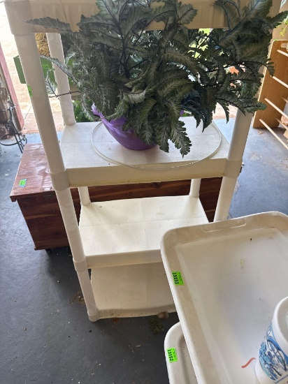 white plastic shelf, with purple greenery