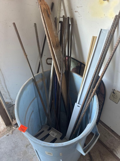 Trash can with rebar, wood pieces and other items