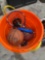 Basketballs, softballs,racket, golf balls in orange bucket
