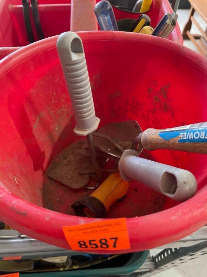 Red bucket with lawn tools