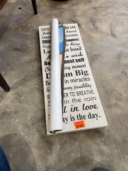 Wall art with saying and a Mater poster