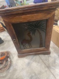 Wooden wall cabinet with glass front with camel and palm tree