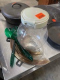 Pizza pan, green serving spoons, clear container